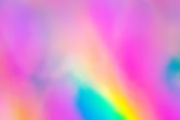Blurry abstract iridescent holographic foil background.