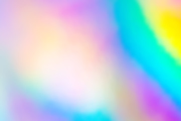 Blurry abstract iridescent holographic foil background.