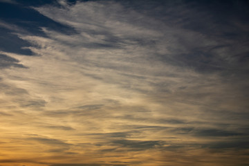 Fototapeta premium Colorful clouds during sunset in full golden hour.