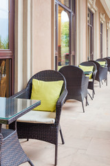 Outdoor coffee terrace with tables and wicker chairs