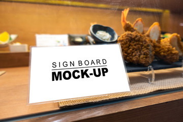 Mock up signboard with plastic frame in restaurant