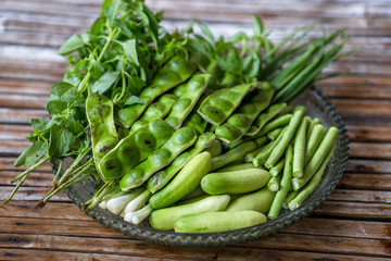 A view of the arrangement of a close-up food set,a healthy vegetable set (cucumber,sato,long-hatched bean)that is placed in a beautiful container and placed on a wooden stick to serve customers again.