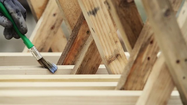 varnishing wooden planks using a brush