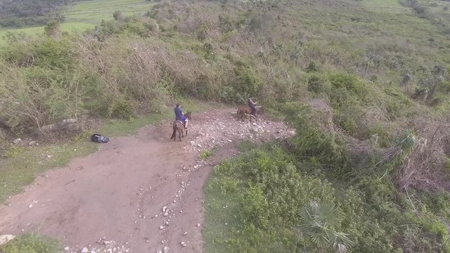 Aerial shot of horseback riders in the mountains of Cuba.