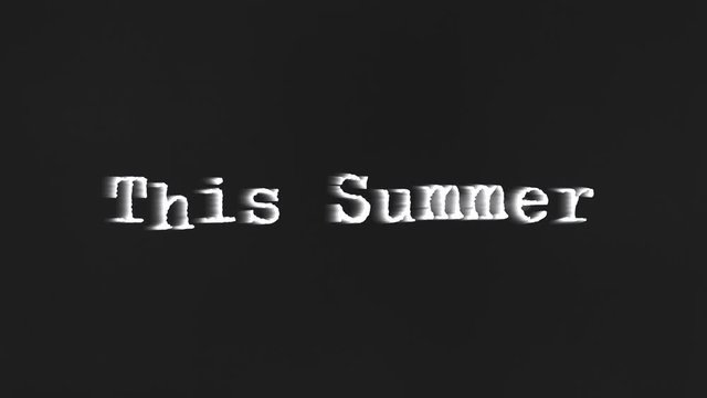 A scary text, This Summer, appearing on the screen with a light behind the typewriter font, typical of a horror flick (b-movie).