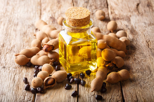 Tasty diet tamarind oil in a glass jar close-up. horizontal