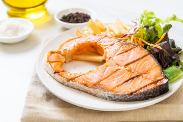 grilled salmon steak fillet with vegetable and french fries