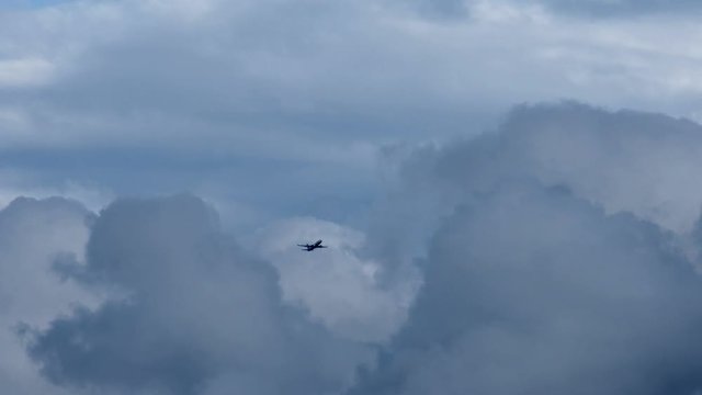 The plane climbs above the storm clouds.