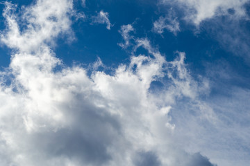 Naklejka na ściany i meble fluffy clouds in the blue sky, the feeling of flight. Background