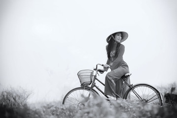 Vietnamese Beautiful woman with traditional dress (ao dai) and conical hat in Ho Chi Minh Vietnam wilderness walk