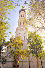 The bell tower of Christian Orthodox church against the background of a clear sky in the afternoon
