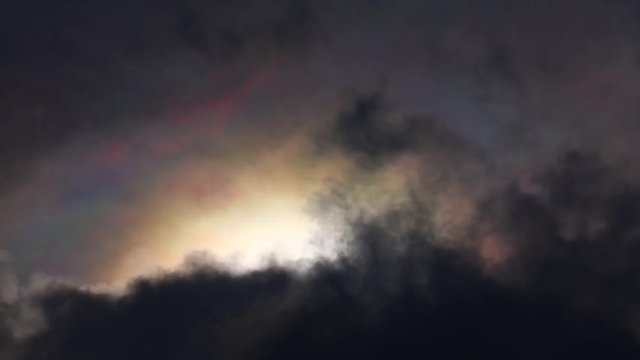 Dramatic iridescence multicoloured time lapse stormy tropical skies with rainbow pastel colours forming. Natural majestic phenomenon caused by small water droplets.