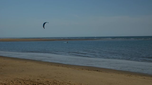 A kitesurfer moving towards left in the Spain&acute;s coast
