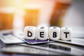 Debt credit card and money coin stack / Increased liabilities from exemption debt consolidation...