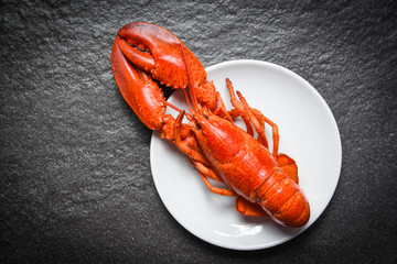 Lobster on white plate with dark background - seafood shrimp prawn