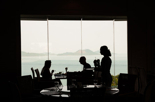 Couple tourists enjoy dinner in a restaurant over Andaman Sea.