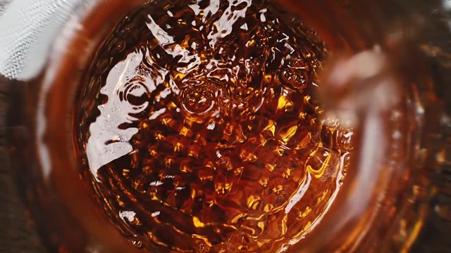 Laowa Lens Comes out of Crystal Decanter with Whisky. Table top View of Ice Cubes Dropped into Glass and Cigar Smoldering in Ashtray. Shot with High Speed Camera, Phantom Flex 4K.