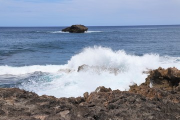 Ocean waves splashing against a rocky coast line