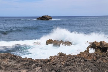 Ocean waves splashing against a rocky coast line