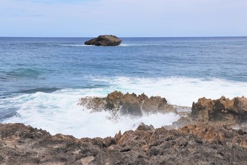 Ocean waves splashing against a rocky coast line