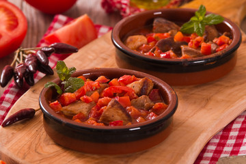 Marinated pork loin in tomato sauce.