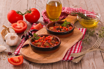 Marinated pork loin in tomato sauce.