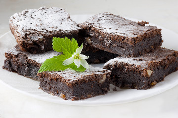 Delicious chocolate cake on a white plate on a white table. Homemade pastries. Traditional American Pie. Copy space