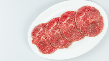 raw beef on a plate .