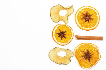 Dried lemon cinnamon star anise on a light background