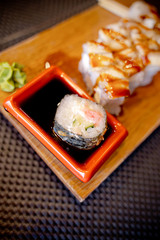 Traditional Asian food sushi on wooden plate.