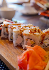 Traditional Asian food sushi on wooden plate.
