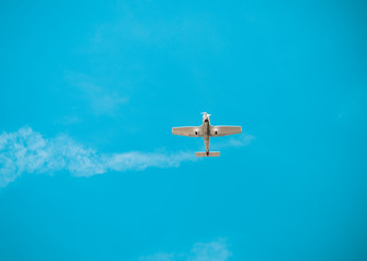 propeller plane in the cloudless blue sky