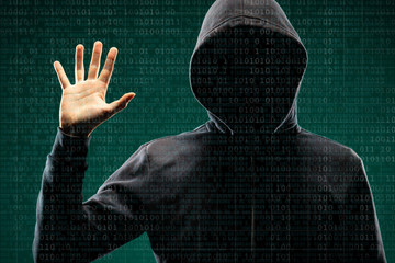 Dangerous hacker over abstract digital background with binary code. Obscured dark face in mask and hood. Data thief, internet attack, darknet fraud, virtual reality and cyber security.