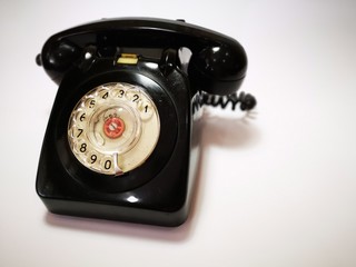 Closeup with 1960's vintage corded telephone with vintage background.