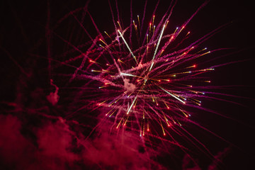 Pruple fireworks exploding on black sky 