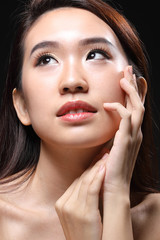 Fototapeta na wymiar Young beautiful Asian woman makeup dark background 