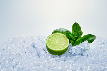 Juicy fresh lime and mint on ice cubes.