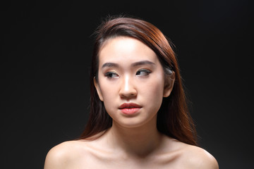 Fototapeta premium Young beautiful Asian woman makeup dark background 