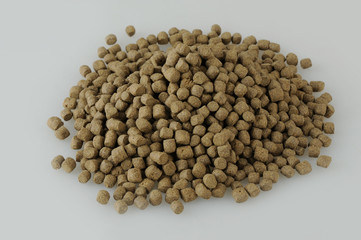 Small middle size swimming, floating fish food for aquarium and pond in round form light brown natural color for many kind of fishes