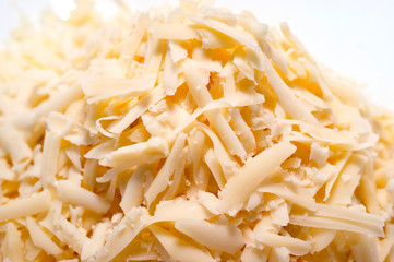Pile of Grated Cheese on White Background. Organic Farming Dairy Products.