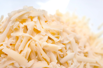 Pile of Grated Cheese on White Background. Organic Farming Dairy Products.