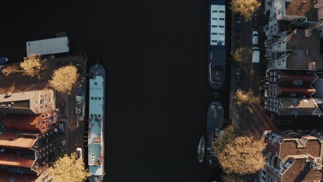 Beautiful aerial view of Amsterdam narrow canals with many boats