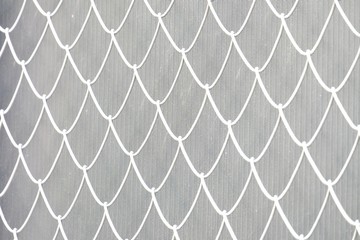 Fototapeta premium Blurred white metal fence on grey template background for backdrop pattern 