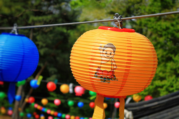 Close up of the hanging colorful lanterns for celebrating Buddha's birthday. The text on lantern means 'Buddha's birthday'. 