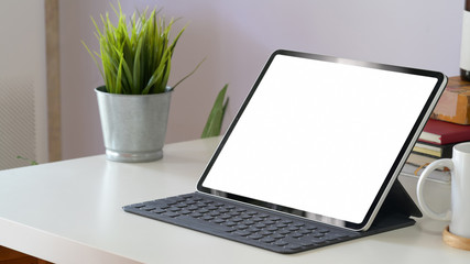 Mockup tablet computer and blank screen on workspace