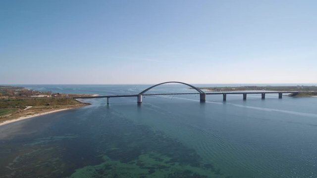 Drone at Fehmarn Bridge and boats, at sunny day, flying backwards
