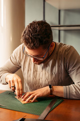 Leather craftsman working with natural leather. Handmade concept. Concept of small business to create leather products.