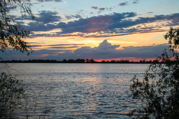 scenic blue and red sunset with beautiful clouds and orange sky on the river danube