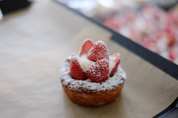 sweet homemade strawberry pie dessert with whipped cream on a table