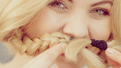 Happy woman having braided blonde hair